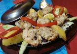 MALAI KEBAB chicken fillet marinated in cream, roasted in tandoor garnished with vegetables